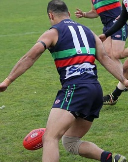 Northern Saints player in the club guernsey — red, green and navy